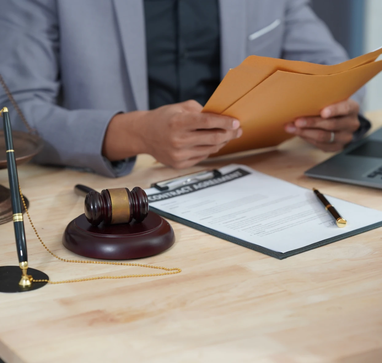 Legal documents and gavel on table