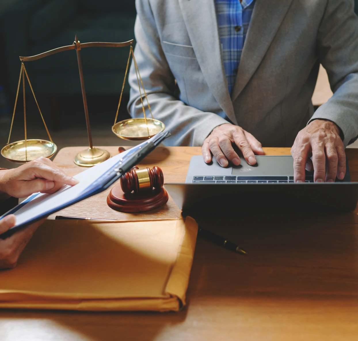 Lawyer working on laptop with documents